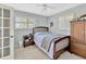 Cozy bedroom featuring a full bed, wood furniture, soft carpet, shutters, and a ceiling fan providing a relaxing atmosphere at 7201 Hodgewood Ct, Tampa, FL 33614