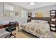 Cozy bedroom with a floral-patterned bedspread, desk, and ample natural light at 7201 Hodgewood Ct, Tampa, FL 33614
