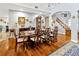 Dining room with hardwood floors, elegant furnishings, and a view of the staircase at 7201 Hodgewood Ct, Tampa, FL 33614