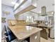 Bright kitchen features a skylight, light cabinets, stainless steel appliances, breakfast bar, and elegant granite countertops at 7201 Hodgewood Ct, Tampa, FL 33614