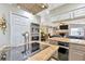 Modern kitchen with stainless steel appliances, granite countertops, and central island with cooktop with easy access to living area at 7201 Hodgewood Ct, Tampa, FL 33614