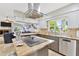 Bright and airy kitchen featuring granite countertops, stainless steel appliances, a modern range hood, and eat-in breakfast bar at 7201 Hodgewood Ct, Tampa, FL 33614