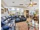 Open concept living room and dining room with black leather furniture and travertine floors at 7201 Hodgewood Ct, Tampa, FL 33614