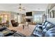 Spacious living room with a brick fireplace, TV, and lake view at 7201 Hodgewood Ct, Tampa, FL 33614