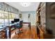 Charming home office with hardwood floors, natural light, and built-in shelving at 7201 Hodgewood Ct, Tampa, FL 33614