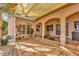 Spacious covered patio with tiled floors, arched doorways, and lush landscaping at 7201 Hodgewood Ct, Tampa, FL 33614