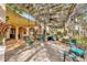 Inviting covered patio featuring hanging swing chairs, lush greenery, and a shaded pergola at 7201 Hodgewood Ct, Tampa, FL 33614
