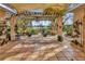 Charming outdoor patio featuring hanging swing chairs and lush greenery overlooking the lake at 7201 Hodgewood Ct, Tampa, FL 33614