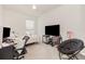 Bedroom featuring a ceiling fan, large window, and lounge area with a chair and table at 8663 Canyon Creek Trl, Parrish, FL 34219