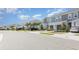 Street view showcasing the row of townhomes, beautiful landscaping, and ample parking at 8663 Canyon Creek Trl, Parrish, FL 34219