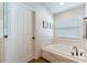 Bathroom featuring stand-alone tub with a modern faucet, window and marble floors at 9729 Patrician Dr, New Port Richey, FL 34655