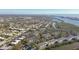 A broad aerial view showcasing the waterfront condo community against a coastal backdrop and lush greenery at 9954 Indian Key Trl # 14, Seminole, FL 33776