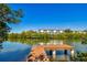 Picturesque dock on the water with a building in the background, offering waterfront living at 9954 Indian Key Trl # 14, Seminole, FL 33776