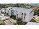 An aerial view shows the condo building's layout, surroundings, and community landscaping at 9960 5Th St. N. # 304, St Petersburg, FL 33702