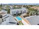 Aerial view of community with a central pool, surrounding buildings, and landscaping at 9960 5Th St. N. # 304, St Petersburg, FL 33702