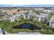 Scenic aerial view of a condo community featuring lush landscaping and a tranquil pond at 9960 5Th St. N. # 304, St Petersburg, FL 33702