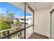 Balcony with views of community buildings, landscaping, and a bright blue sky at 9960 5Th St. N. # 304, St Petersburg, FL 33702
