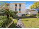 Inviting condo exterior featuring manicured landscaping, street lamp, and a welcoming walkway at 9960 5Th St. N. # 304, St Petersburg, FL 33702