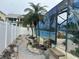 This backyard features a decorative stone walkway and lush palm trees near the pool at 19109 Gulf Blvd, Indian Shores, FL 33785
