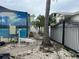 Outdoor view of the side yard with landscaping around pool equipment and fence at 19109 Gulf Blvd, Indian Shores, FL 33785