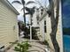 This neighborhood view features a home with colorful palm trees in between houses at 19109 Gulf Blvd, Indian Shores, FL 33785