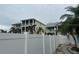 This exterior is a neighborhood view of multi story homes with screened-in balconies at 19109 Gulf Blvd, Indian Shores, FL 33785