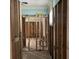 Hallway interior shows a room down to the studs and subfloor, with pipes at 19109 Gulf Blvd, Indian Shores, FL 33785