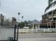 Neighborhood view of a gazebo and charming homes with white picket fences at 19109 Gulf Blvd, Indian Shores, FL 33785