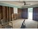 View of room down to the studs with aqua trim, plywood subfloor and doorway at 19109 Gulf Blvd, Indian Shores, FL 33785