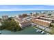 Aerial view of condos with waterfront views on a clear, sunny day, with boats docked nearby at 19651 Gulf Blvd # A6, Indian Shores, FL 33785