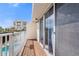 Private balcony with views of the resort-style swimming pool and surrounding lush landscaping at 19651 Gulf Blvd # A6, Indian Shores, FL 33785