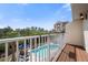 Relaxing balcony with great views of the tropical foliage and community pool at 19651 Gulf Blvd # A6, Indian Shores, FL 33785
