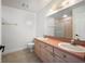 Bright bathroom with a double sink vanity, large mirror, and pink tiled shower at 19651 Gulf Blvd # A6, Indian Shores, FL 33785