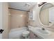 Full bathroom featuring tub-shower combo, decorative wallpaper, and ample counter space at 19651 Gulf Blvd # A6, Indian Shores, FL 33785