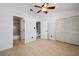 Bedroom featuring wood-look floors, a ceiling fan, and ensuite bath at 19651 Gulf Blvd # A6, Indian Shores, FL 33785