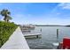 Dock with boats and view of the water with trees nearby and clear sky at 19651 Gulf Blvd # A6, Indian Shores, FL 33785