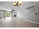 Bright living room with wood-look tile, fireplace, ceiling fan, and sliding door access to the balcony at 19651 Gulf Blvd # A6, Indian Shores, FL 33785