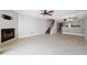 Open-concept living area with fireplace, staircase, and view into the updated kitchen at 19651 Gulf Blvd # A6, Indian Shores, FL 33785