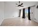 Spacious main bedroom with ceiling fan and sliding door to a private balcony at 19651 Gulf Blvd # A6, Indian Shores, FL 33785