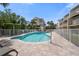 Community pool area featuring a pool, lounge chairs, and a nearby building at 19651 Gulf Blvd # A6, Indian Shores, FL 33785