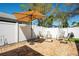 Charming backyard with a stone patio, seating area, and lush landscaping at 2009 Sheffield Ct, Oldsmar, FL 34677