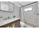 Modern bathroom featuring marble tiled shower and floors with updated vanity and medicine cabinet at 2009 Sheffield Ct, Oldsmar, FL 34677