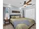 Comfortable bedroom with a ceiling fan, tile floors, and natural light from two windows at 2009 Sheffield Ct, Oldsmar, FL 34677