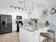 Modern kitchen with white cabinets, granite countertops, stainless steel appliances, and a breakfast bar at 2009 Sheffield Ct, Oldsmar, FL 34677