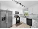 Bright kitchen features stainless steel appliances, granite counters, and white cabinetry at 2009 Sheffield Ct, Oldsmar, FL 34677