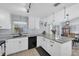 Bright kitchen with white cabinets, granite countertops, stainless steel appliances, and a breakfast bar at 2009 Sheffield Ct, Oldsmar, FL 34677