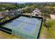 Aerial view of two well-maintained community tennis courts next to parking and green space at 2009 Sheffield Ct, Oldsmar, FL 34677