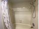 Bright bathroom features a shower and bathtub combination with tiled walls at 2131 Ridge S Rd # 86, Largo, FL 33778