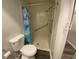 The bathroom features a walk in shower with safety railings, and a blue dolphin shower curtain at 2131 Ridge S Rd # 86, Largo, FL 33778