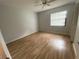 The bright bedroom boasts hardwood floors, a ceiling fan, and lots of natural light at 2131 Ridge S Rd # 86, Largo, FL 33778